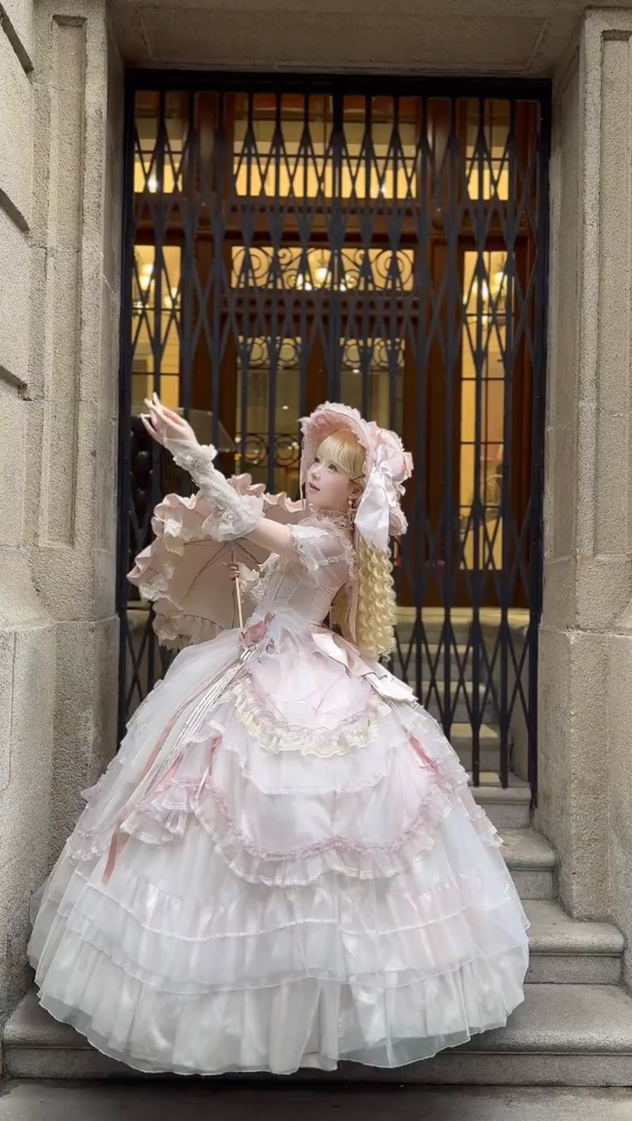Elegant pink dress with bonnet and parasol