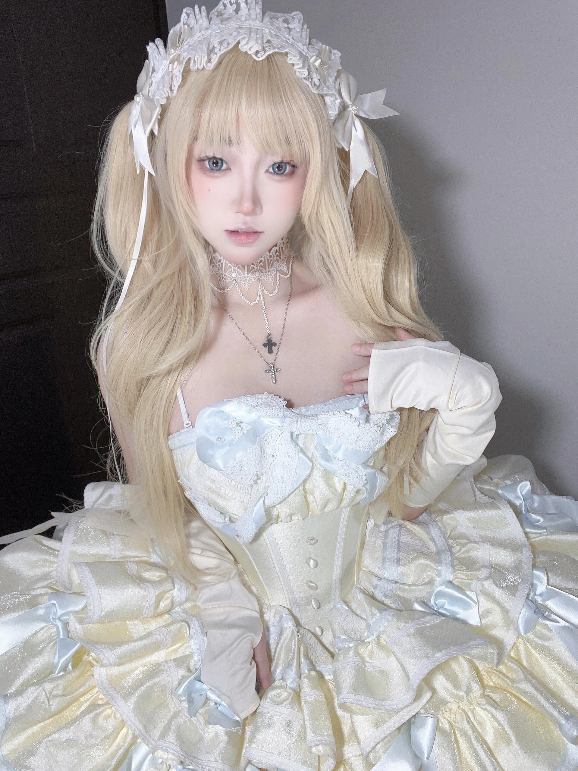 Model wearing a Short Off Shoulder Lolita Dress with bows and frills from Sukuroi