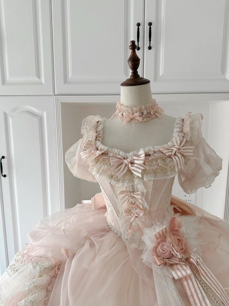 Close-up of pink Lolita dress with ribbons