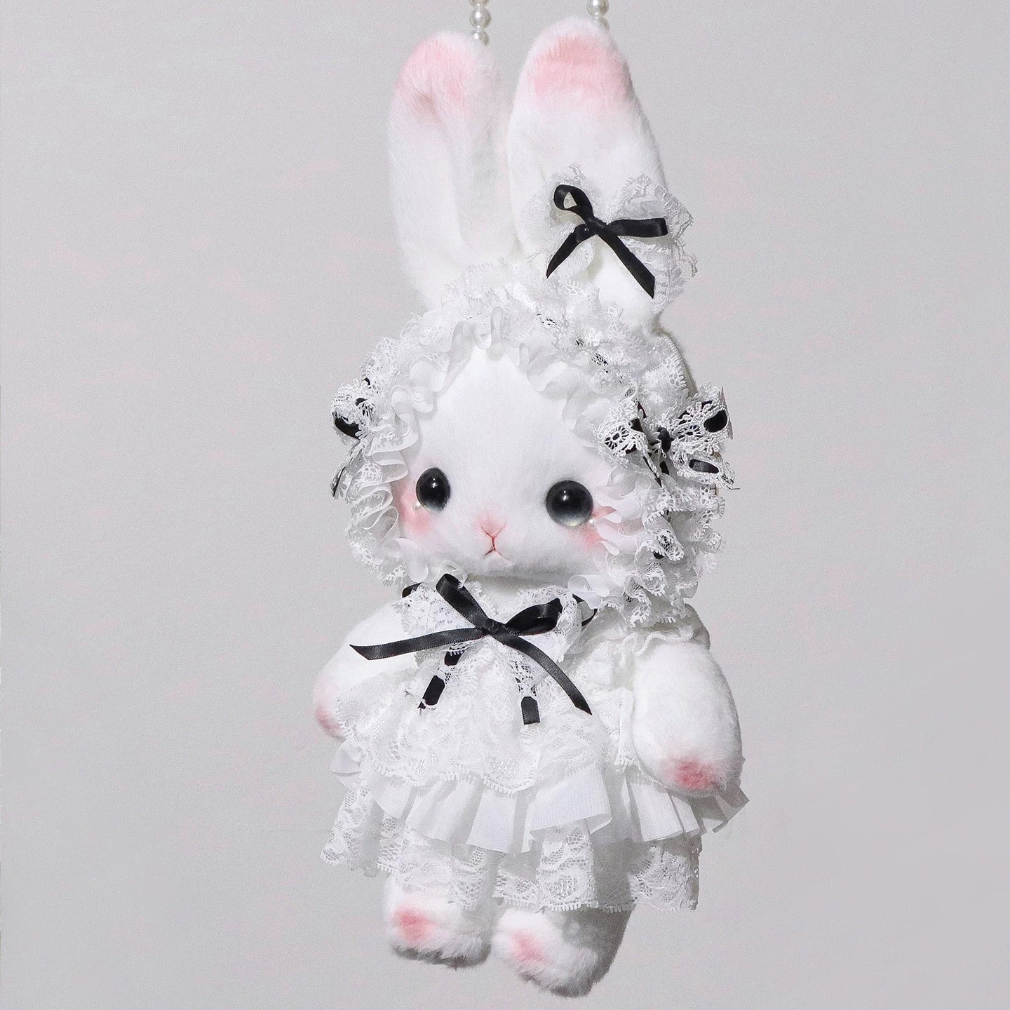 Elegant plush bunny bag with black ribbon bows