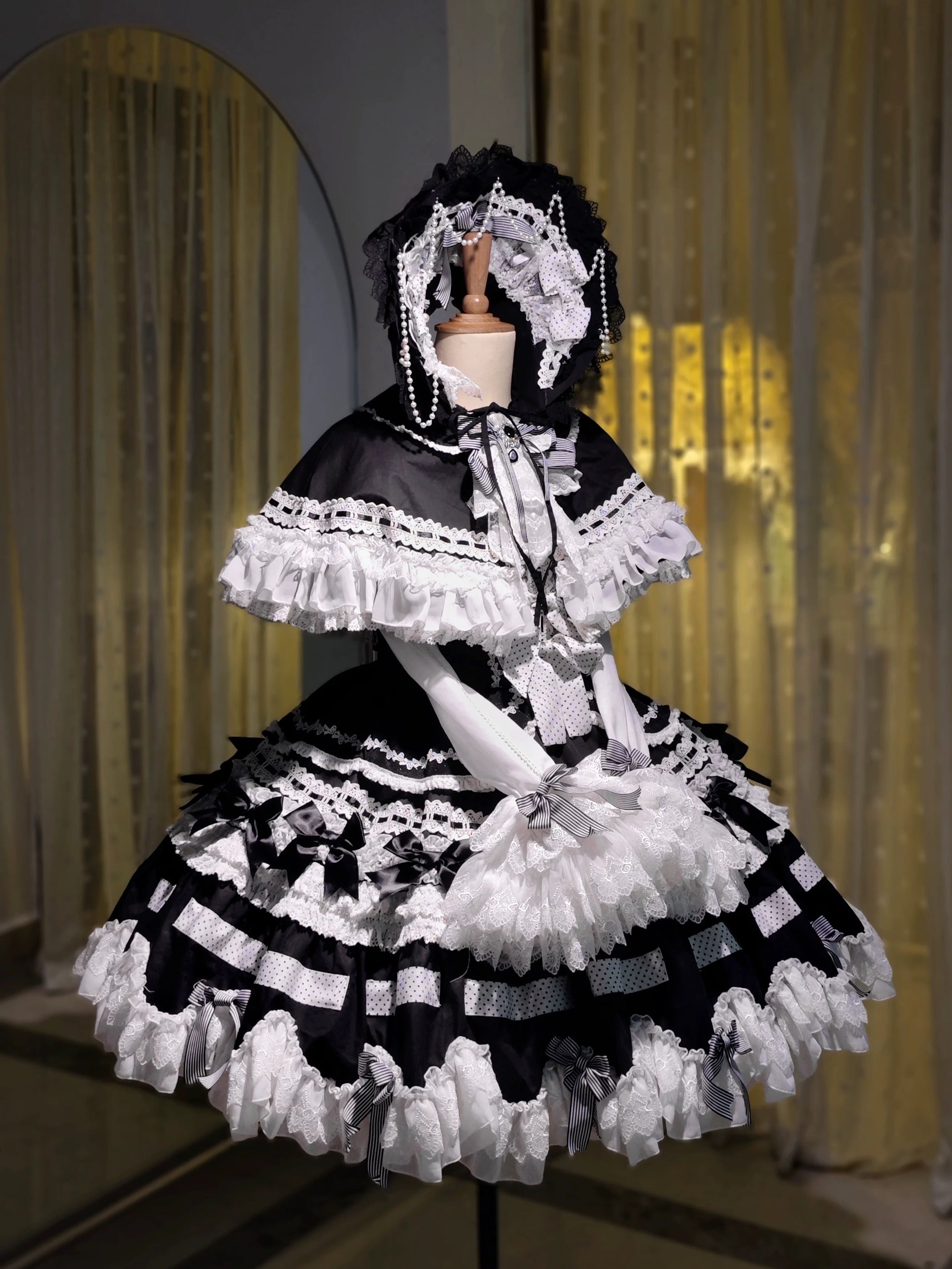 Gothic Lolita outfit with cape and ribbon lacing