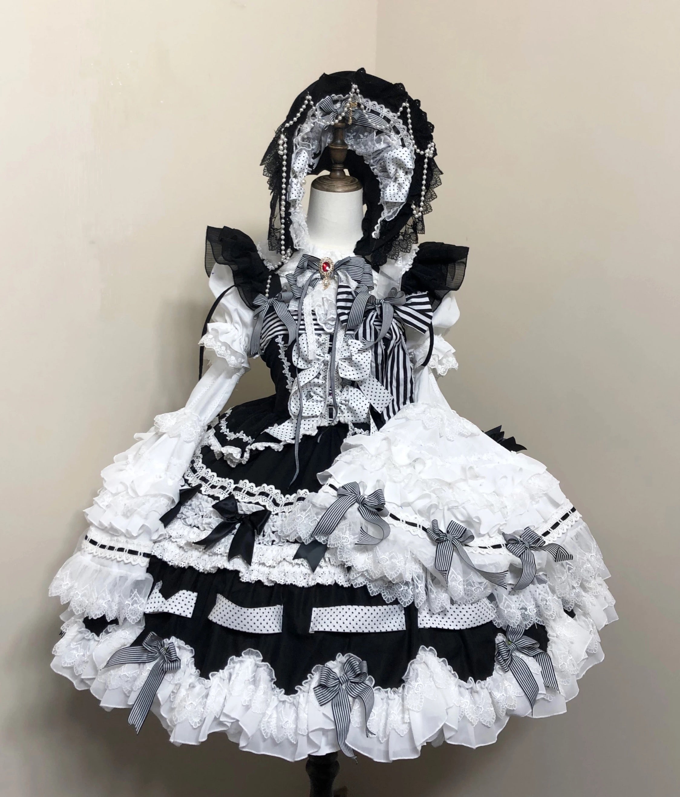Gothic Lolita outfit with accessories and bonnet