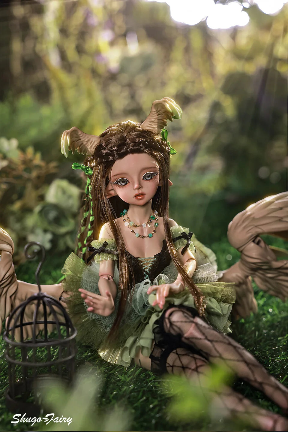 ShugaFairy Pegasus BJD doll with wings sitting in a green tutu and fishnet stockings