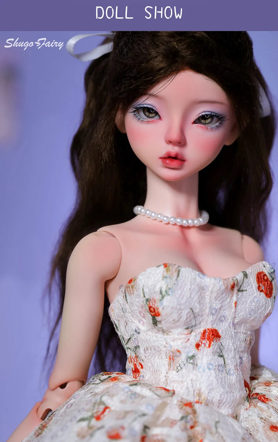 Close-up of BJD doll in a white Doll Floral Dress with orange accents and pearl necklace