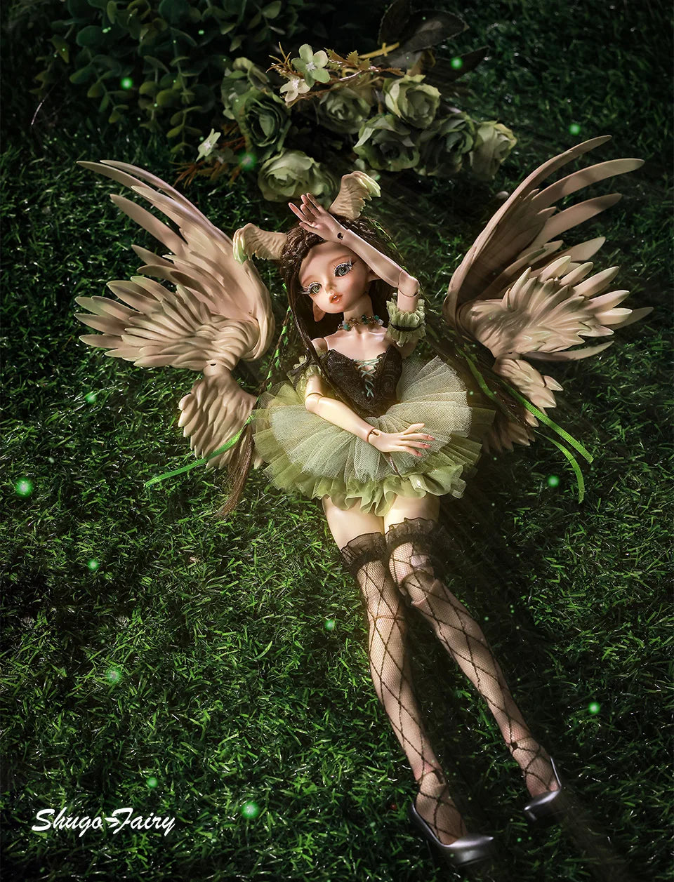 ShugaFairy Pegasus doll with angel wings and green tutu, lying on grass in a whimsical pose