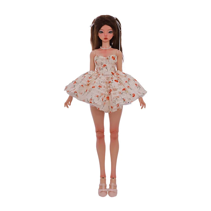 Doll wearing a white Doll Floral Dress with orange floral prints, standing against a plain background