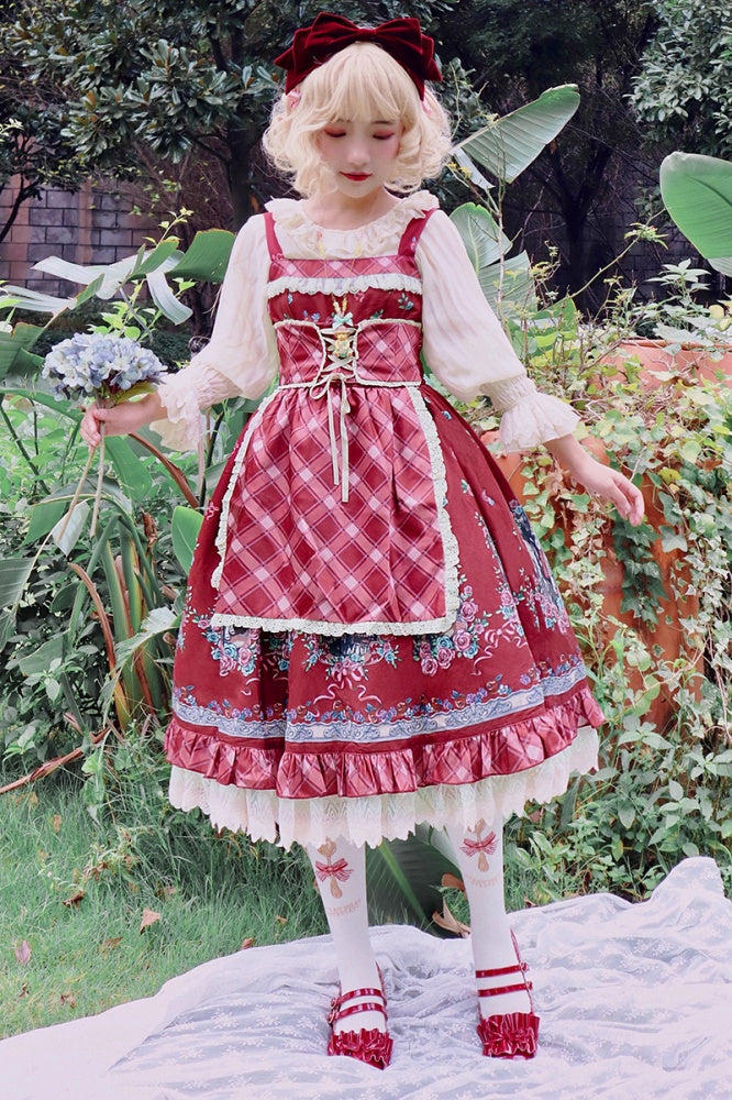 Model wearing Little Red Riding Hood jumper skirt in a garden holding flowers