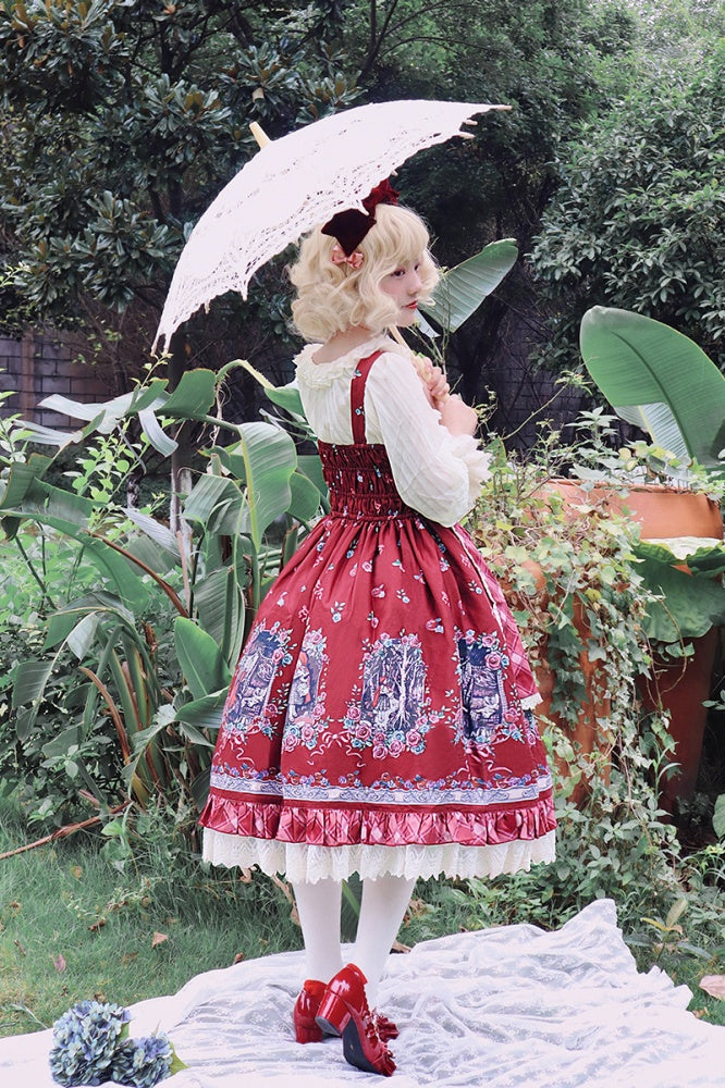 Back view of model wearing Little Red Riding Hood jumper skirt with lace parasol in garden