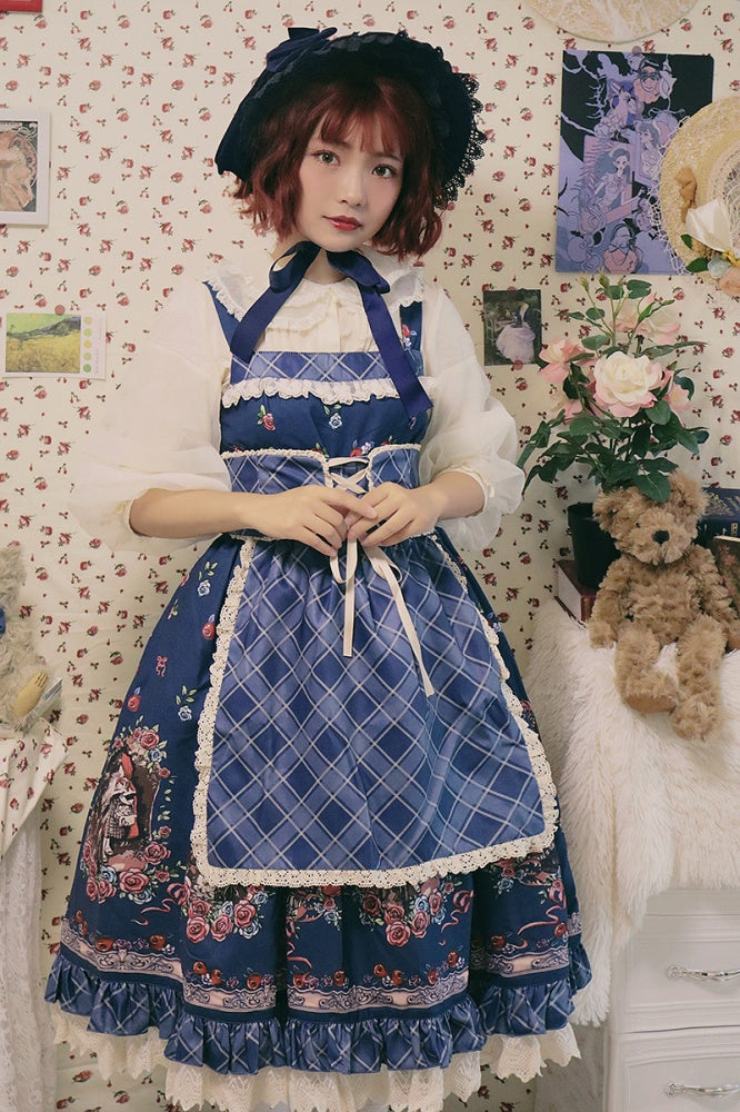 Model wearing blue Little Red Riding Hood jumper skirt with lace details and matching bonnet