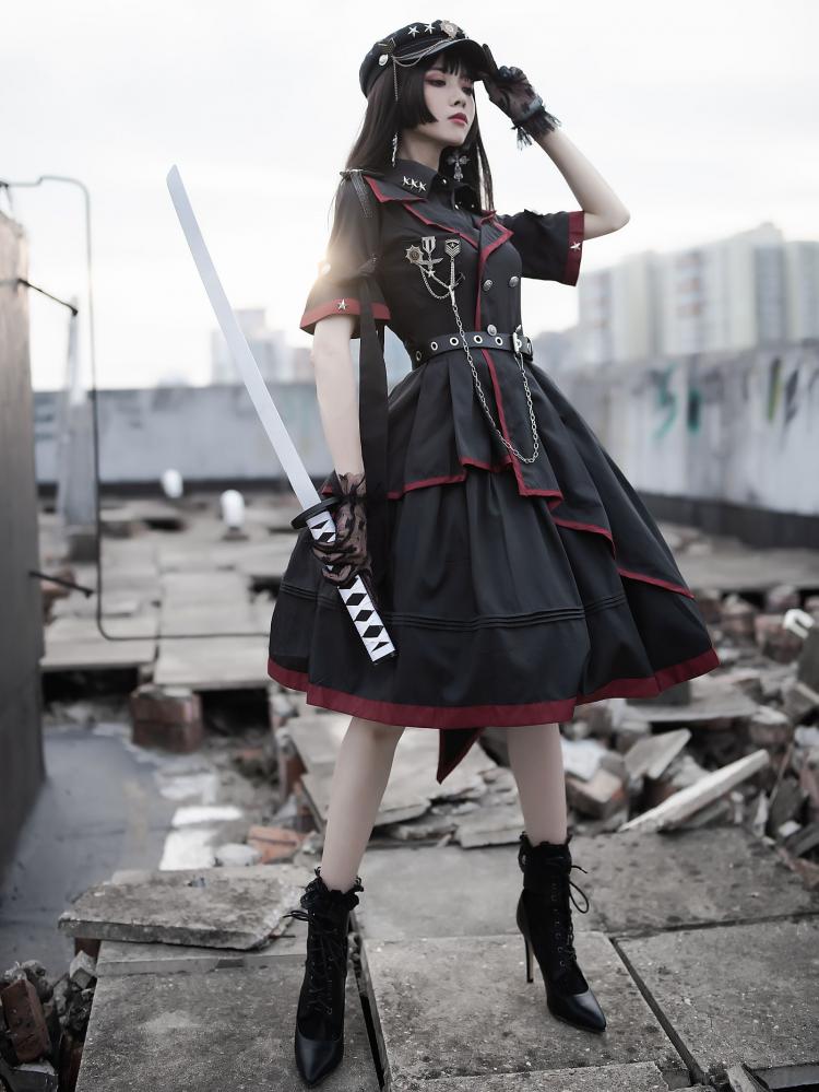 Woman in black Gothic military dress with red trim holding a sword