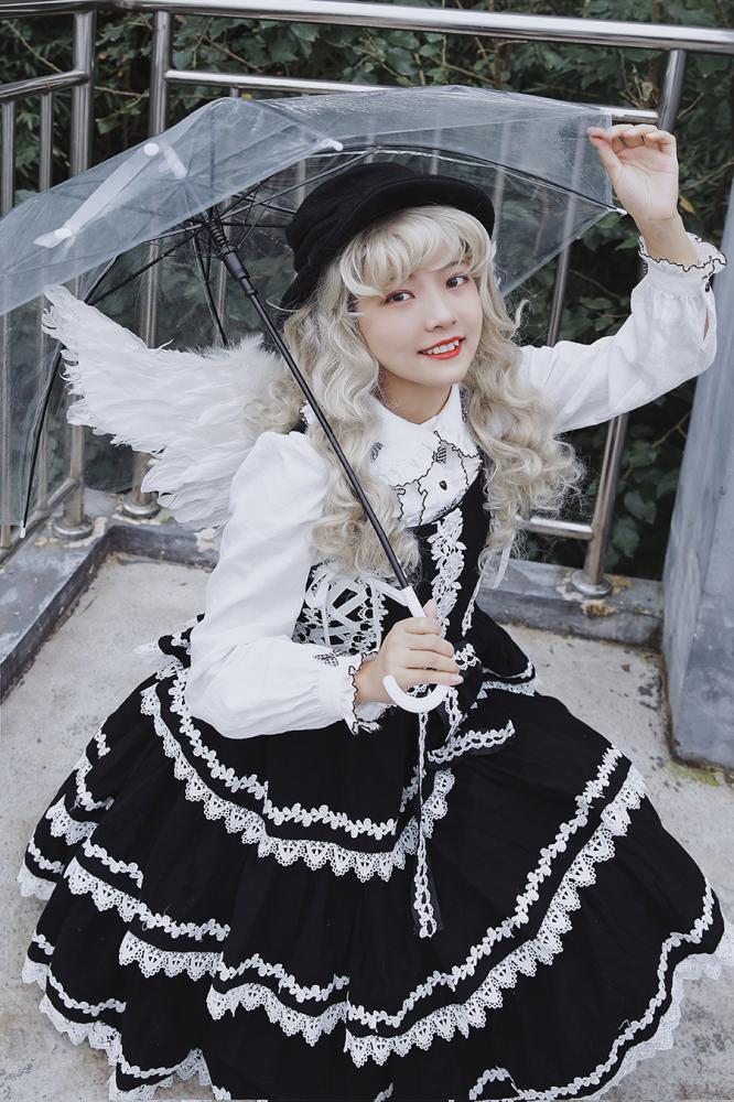 Black Cake Tree Tiered Flounce Skirt styled with white blouse, lace accents, and clear umbrella for a whimsical look