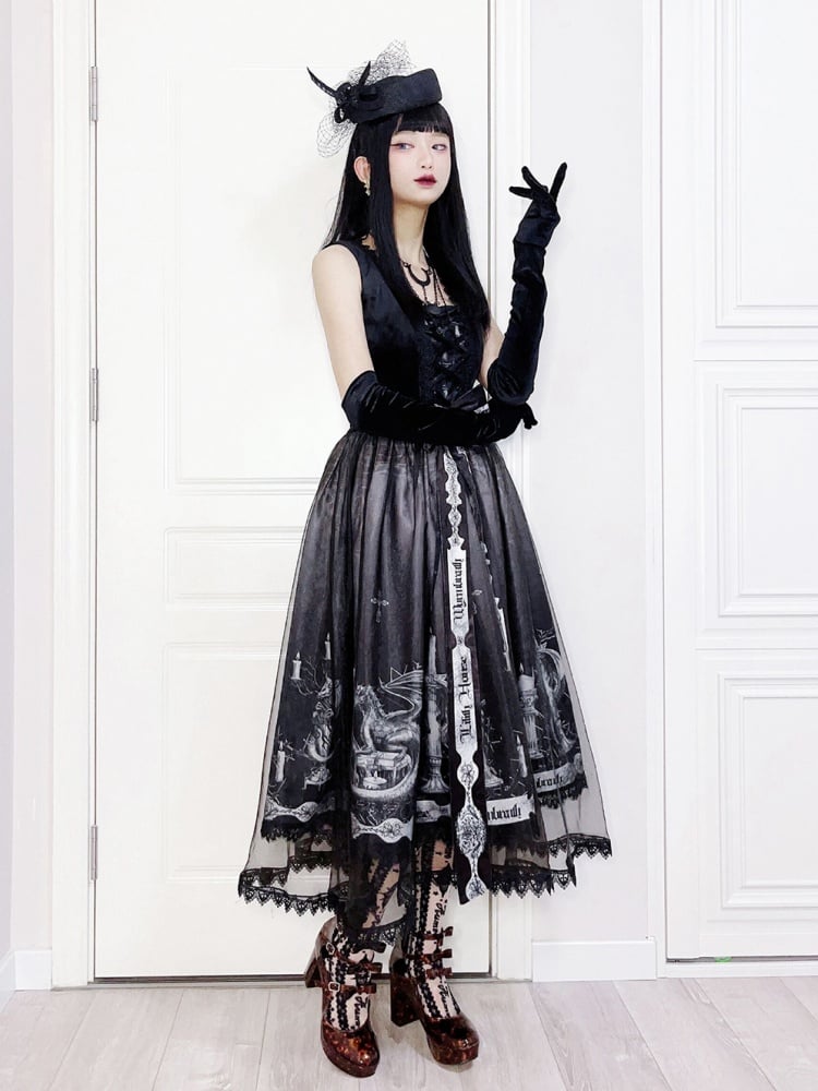 Woman in gothic fashion wearing black jumper skirt with dragon print