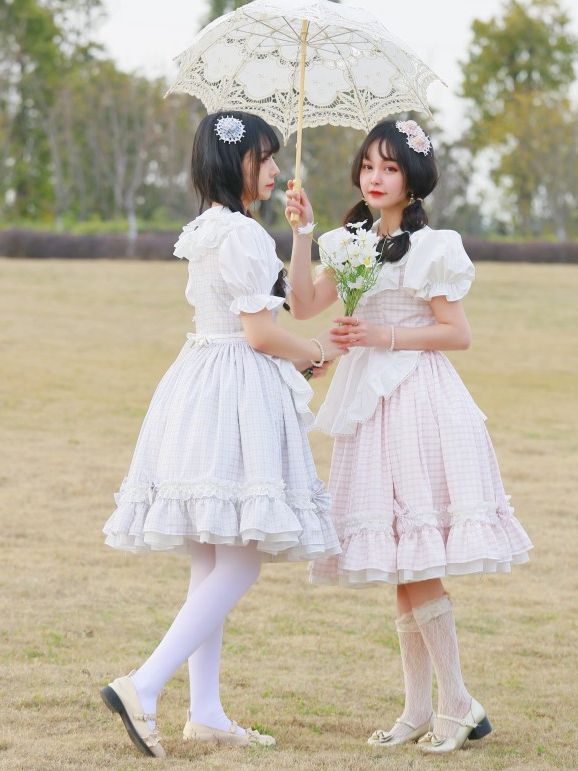 Girls in lolita gingham dresses with flowers and umbrella