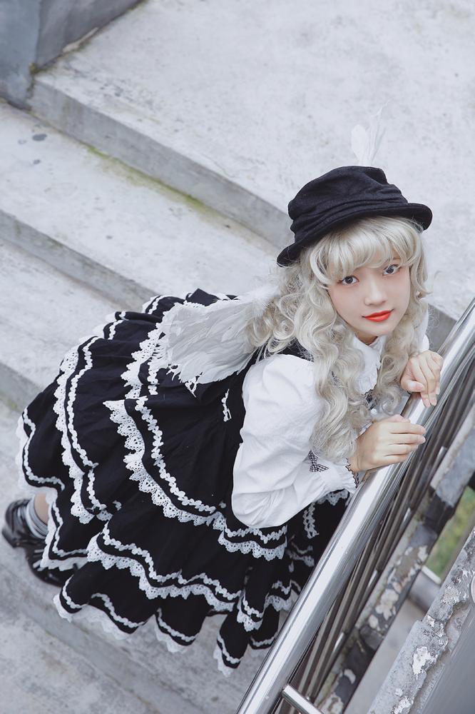 Cake Tree Tiered Flounce Skirt in black with white trim, styled with a white blouse and hat