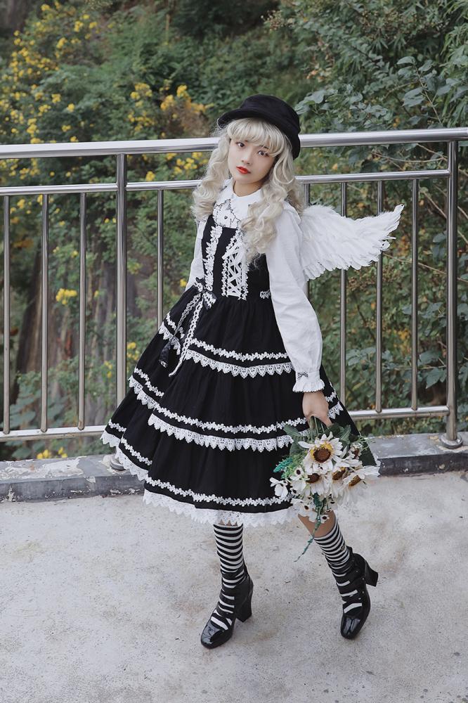Black Cake Tree Tiered Flounce Skirt styled with striped socks, white blouse, and floral bouquet